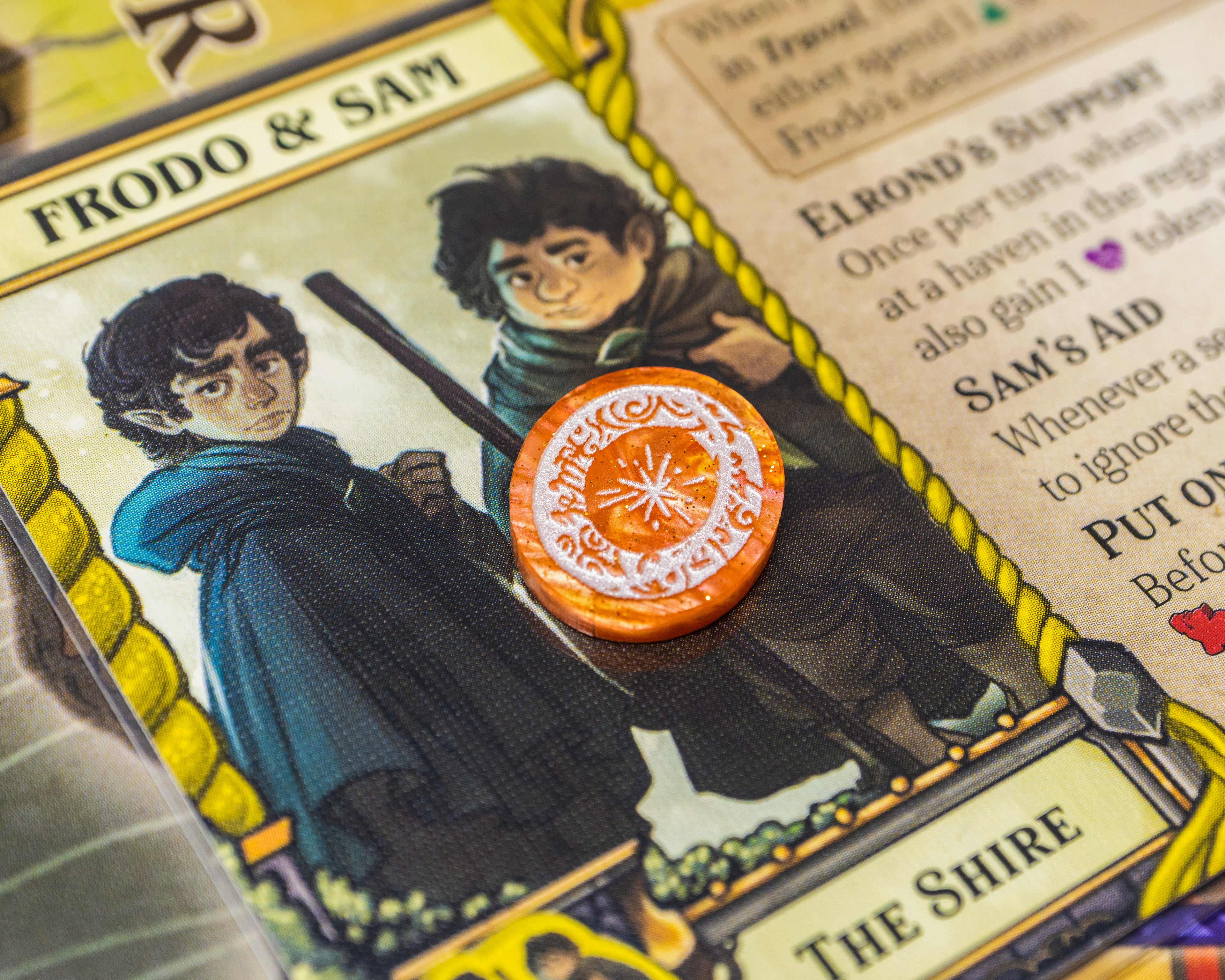 The One Ring painted white on a fiery orange marble acrylic represents Resistance.