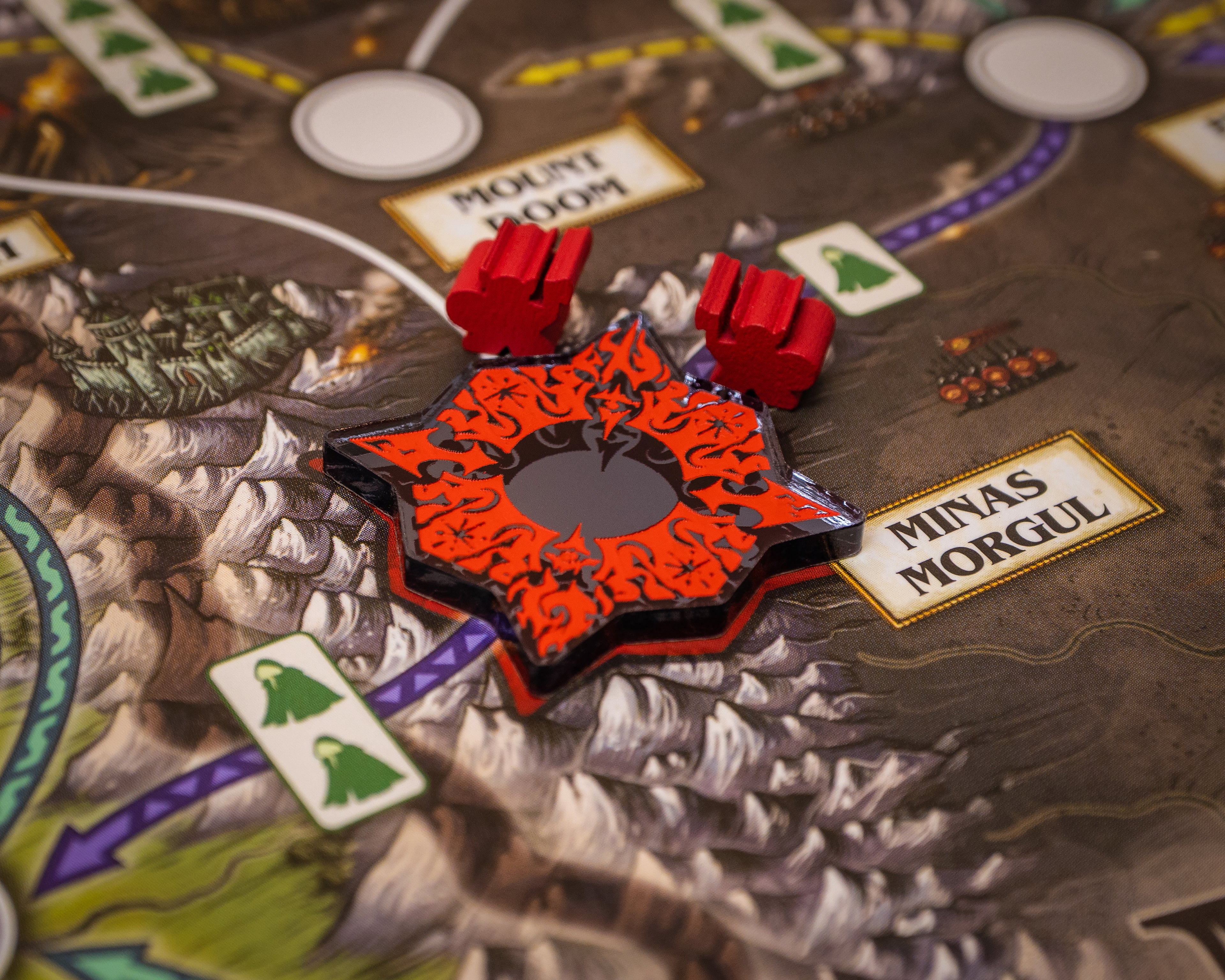 Arrows and swirls painted red on black mirror material represents Stronghold. 